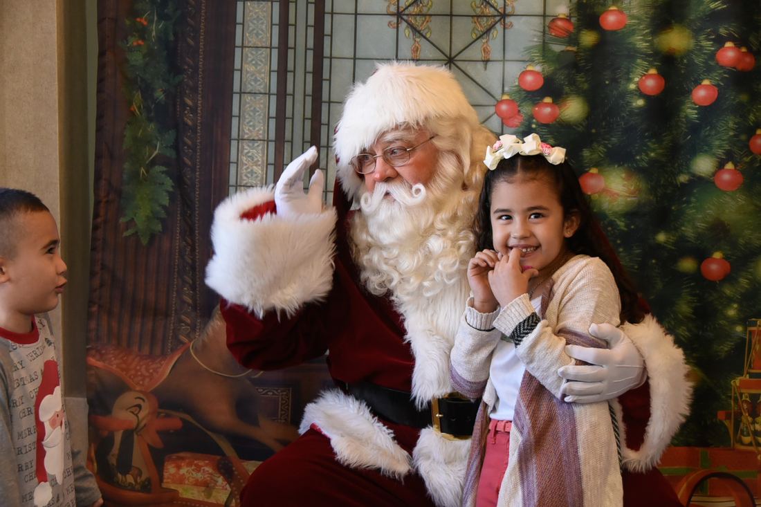 Children meeting Santa at the office
