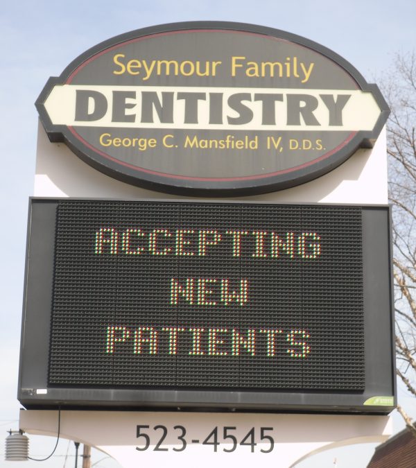 The Seymour Family Dentistry sign on Tipton Street, with its LED board reading “Accepting new patients”